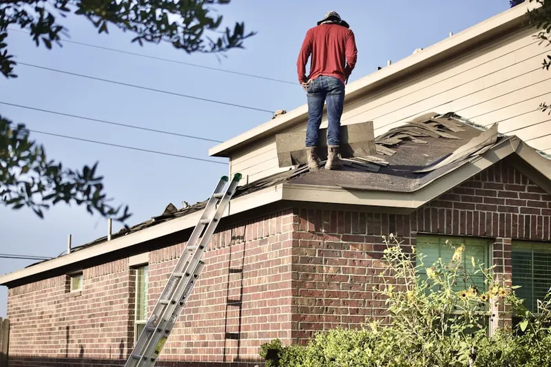 Professional roofer working on a residential roof in Indian Springs Village